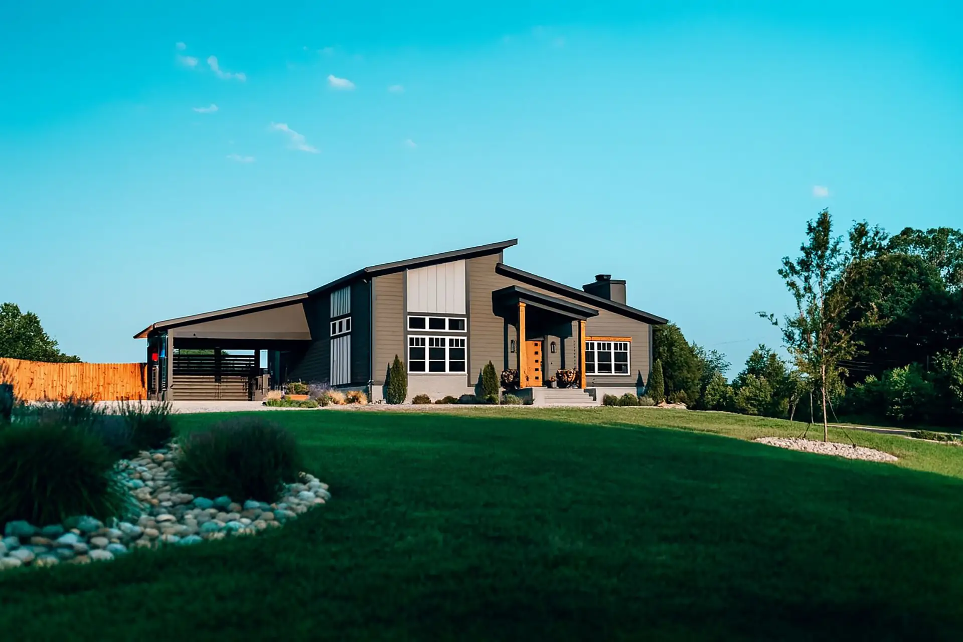 Modern custom home with low-slope rooflines, expansive lawn, and contemporary exterior finishes.