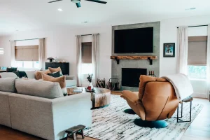 Living room with custom fireplace, mounted television, and comfortable seating area.